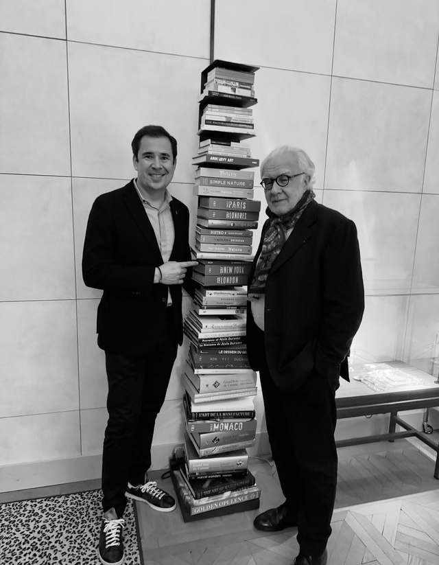 Christophe Sadonès with Mr. Alain Ducasse beside a tower of his books